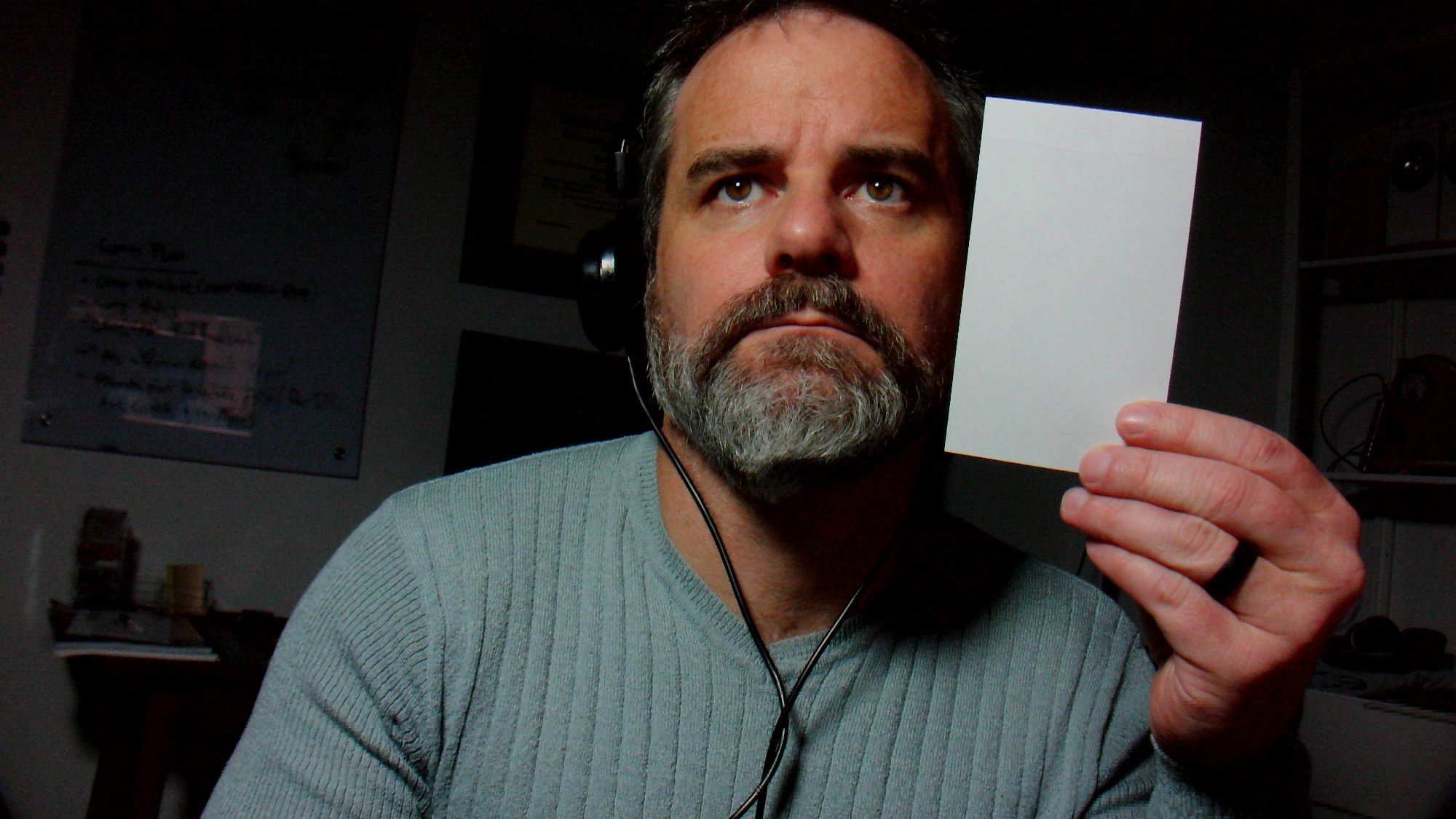 A dude holding a white index card